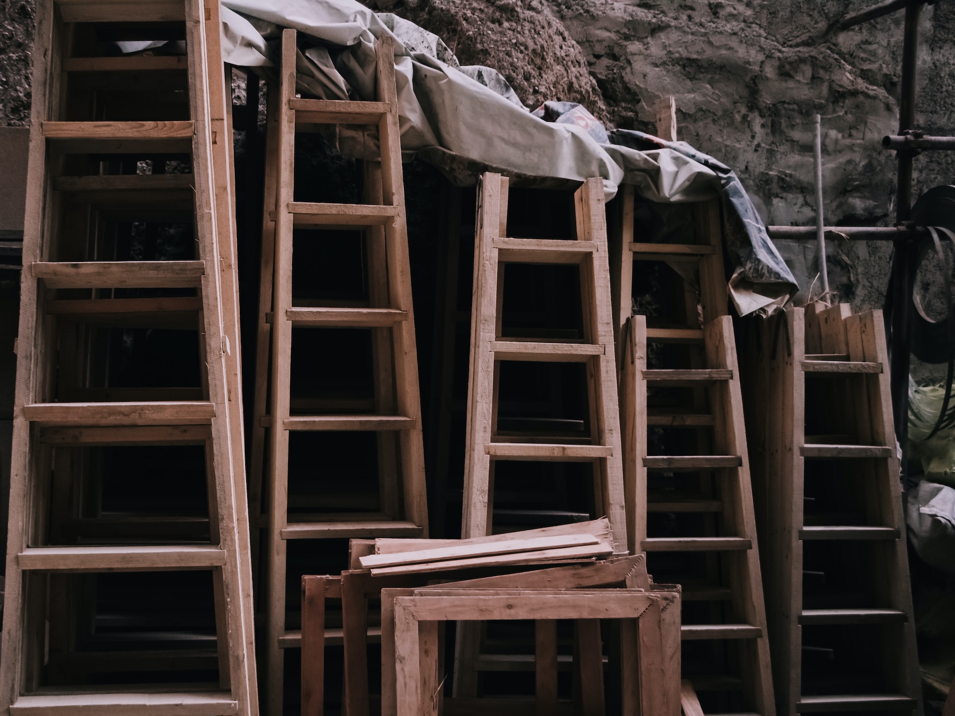 A collection of wooden ladders, both tall and small.