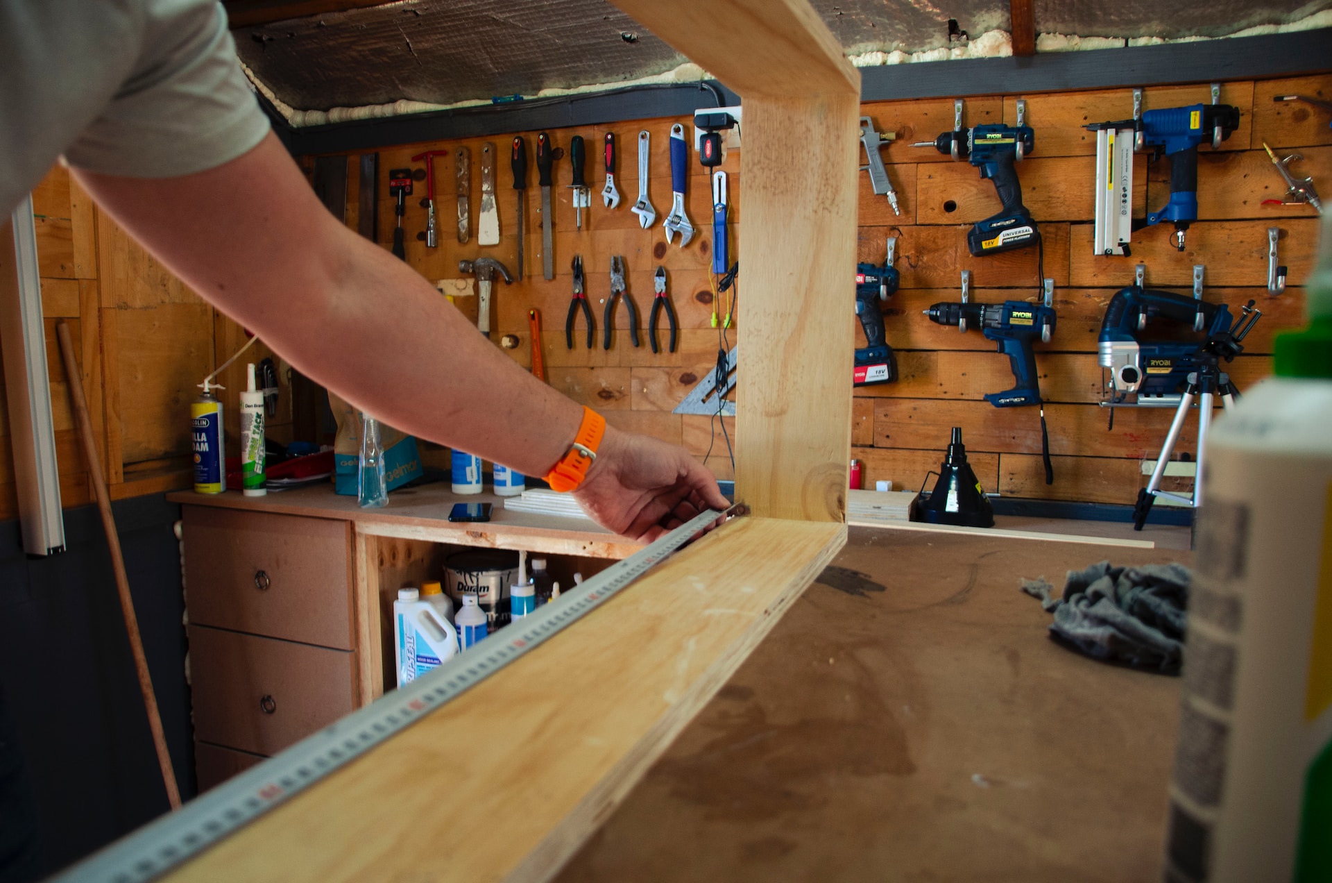 Skilled carpenter crafting a wooden frame in the workshop.